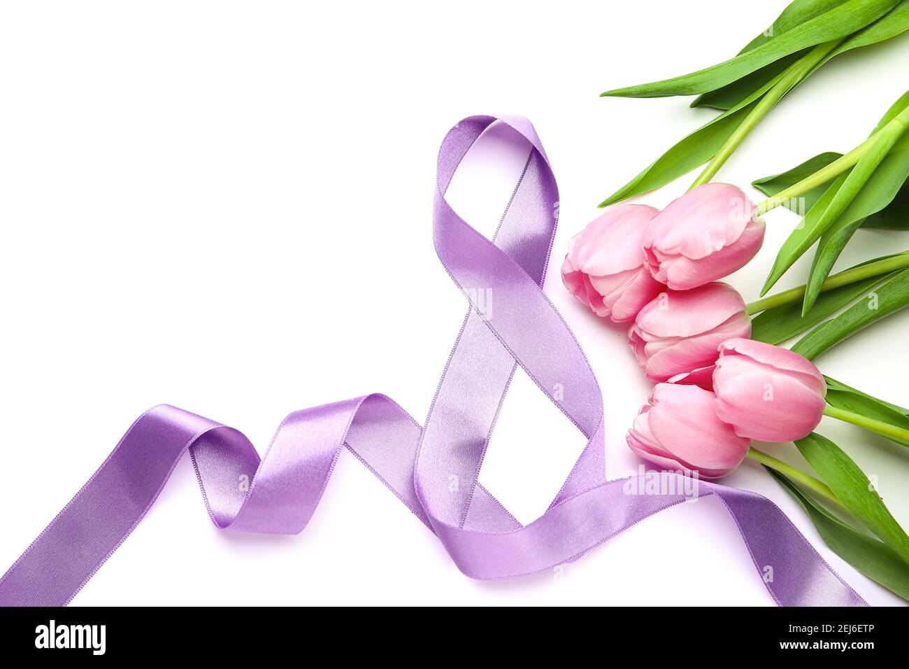 Figure 8 made of violet ribbon and tulip flowers on light background ...