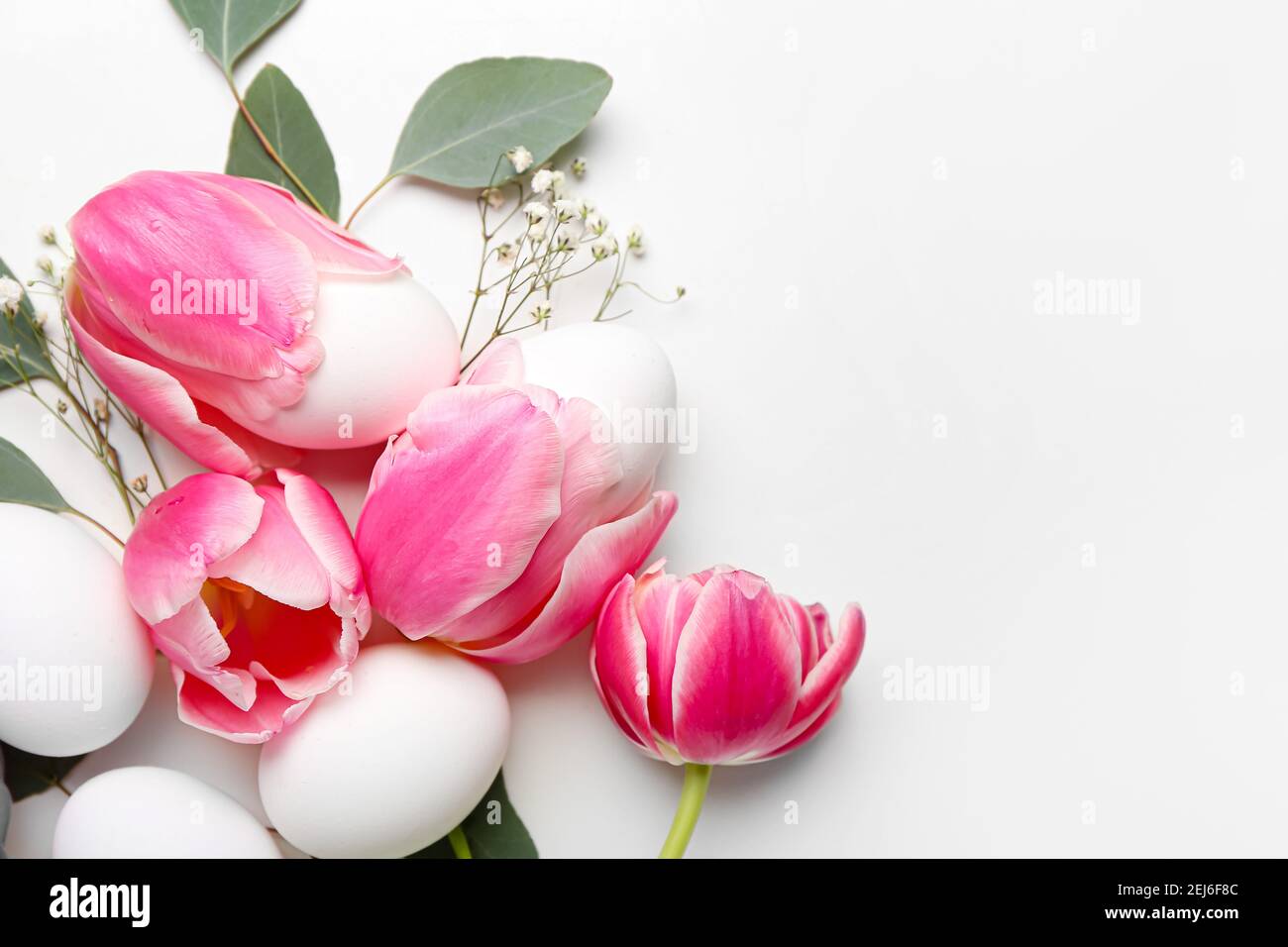 Beautiful Easter composition with eggs and spring flowers on white ...