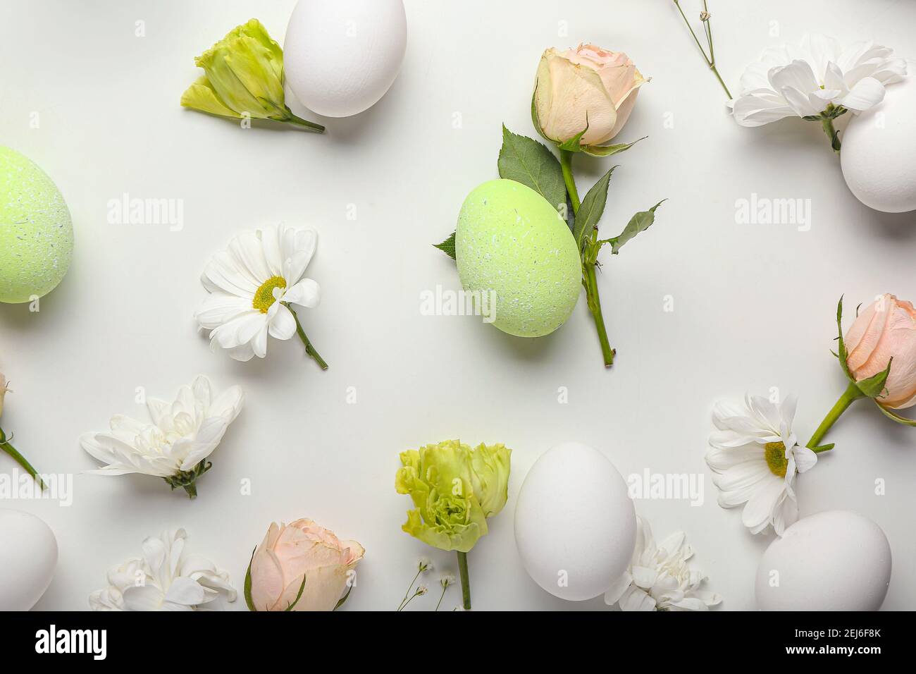 Beautiful Easter composition with eggs and spring flowers on white ...