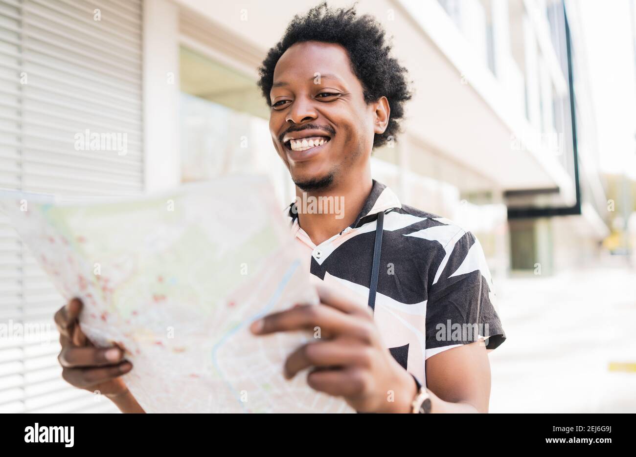 Tourist man looking for directions on map Stock Photo Alamy