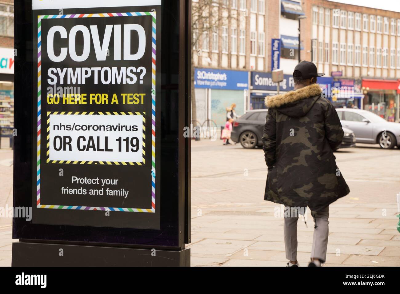 Covid symptoms sign display on LED screen on high street, London Stock Photo