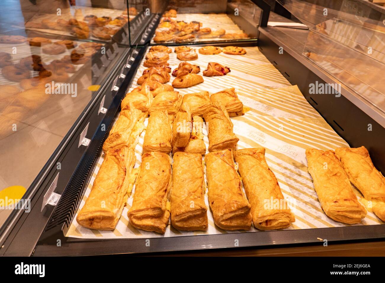 Variety of baked products at a supermarket. Display of a bakery there is a wide variety of baked goods to offer Stock Photo