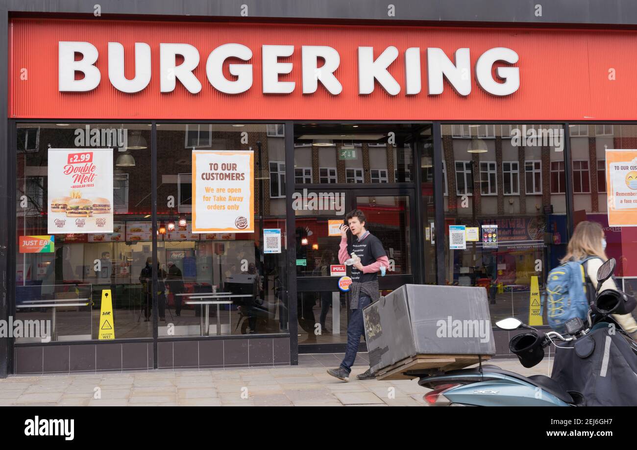 man visiting Burger king restaurant with takeaway, fast food Stock Photo