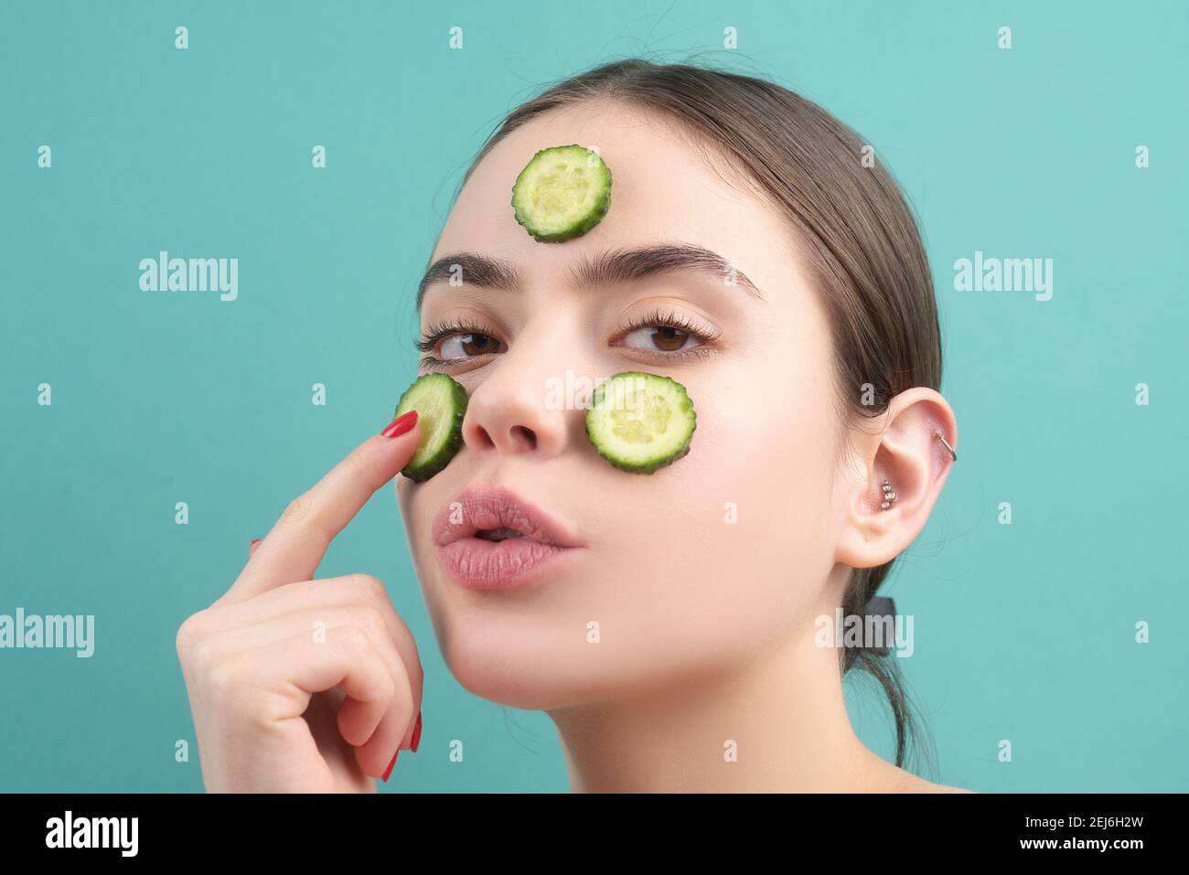 Facial mask. Skin care. Young Woman with cucumber slices on the face