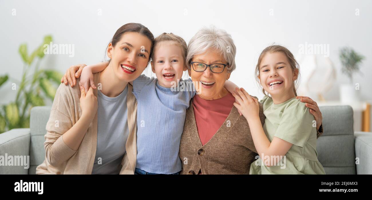 A nice girls, their mother and grandmother are hugging and enjoying ...