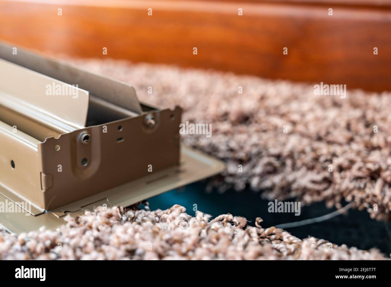 HVAC floor vent opened with carpet and piping visible Stock Photo Alamy