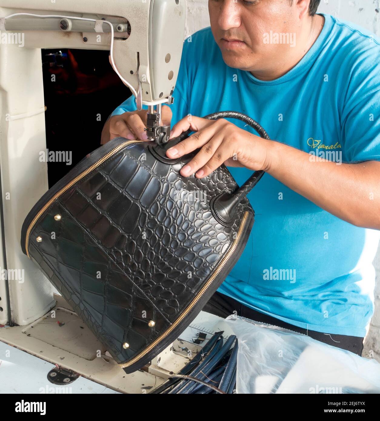 Man sewing a leather handbag in Mexico Stock Photo