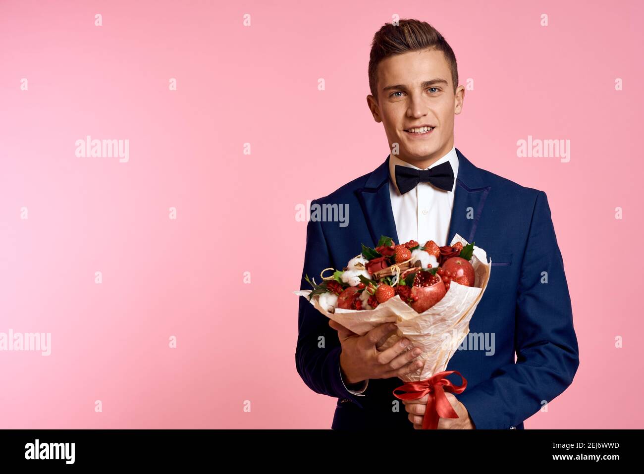 man in a suit bouquet of flowers romance date pink background Stock ...