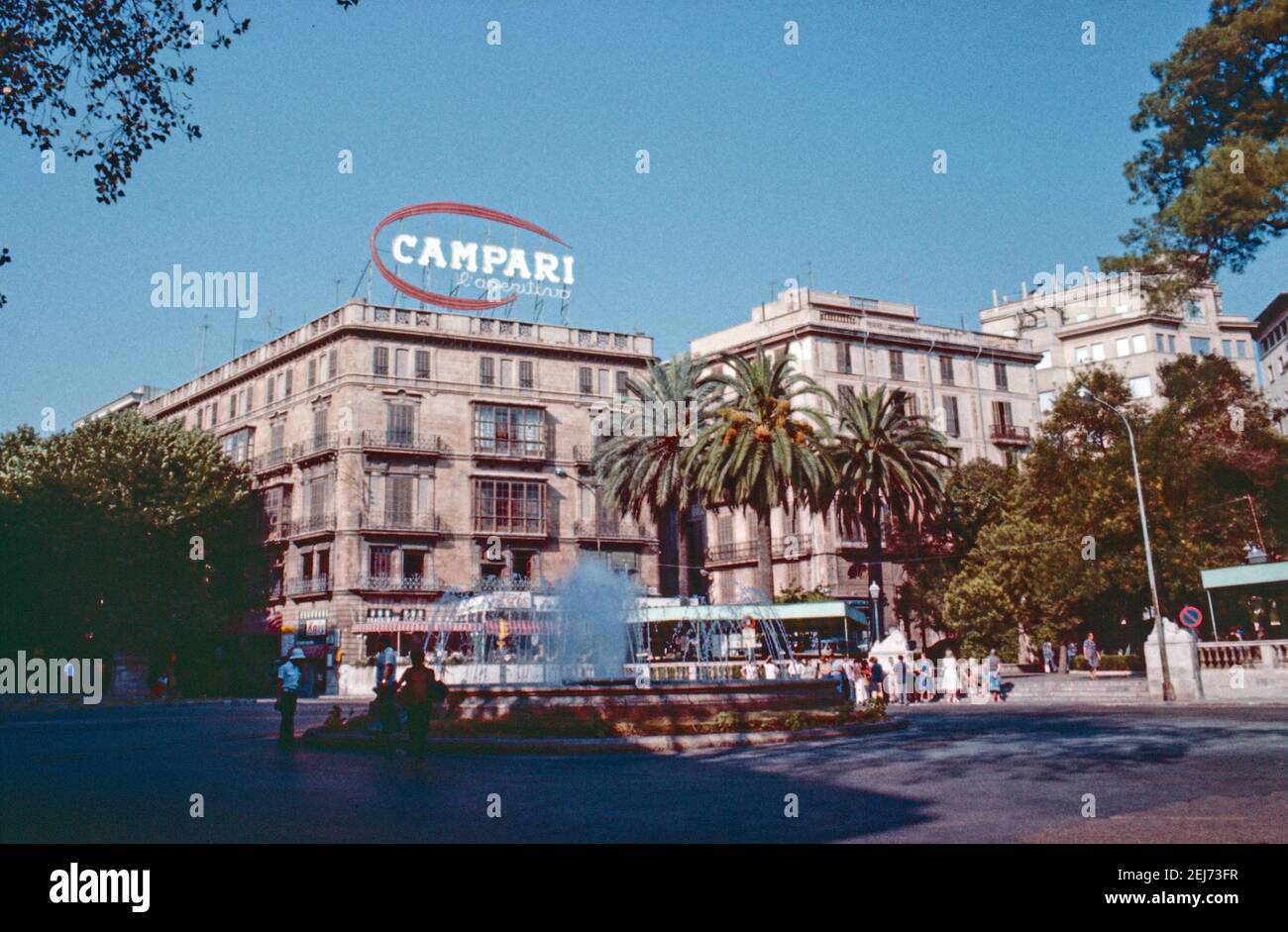 Archive scan of Palma Majorca approx 1975. A Campari sign stands pproud on top of a building, a forground fountain is active Stock Photo