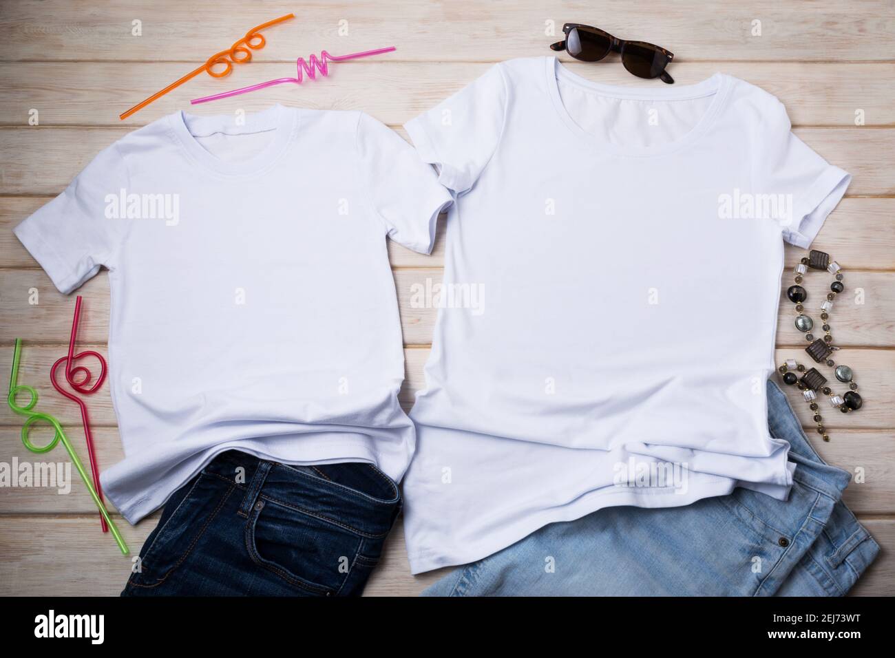 White family look cotton T-shirt mockup with necklace, sunglasses, jeans and decorative cocktail drinking straws. Design t shirt set template, tee pri Stock Photo