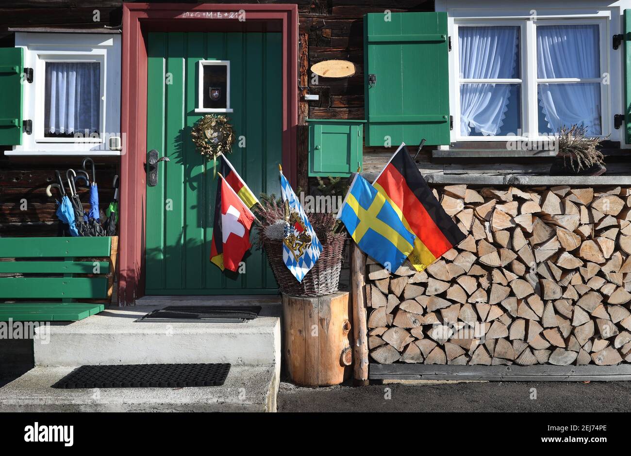 Oberstdorf, Germany. 21st Feb, 2021. Different flags stand for decoration  in front of a farmhouse. From 23.02.-07.03.2021 the FIS Nordic World Ski  Championships will take place in Oberstdorf. Credit: Karl-Josef  Hildenbrand/dpa/Alamy Live