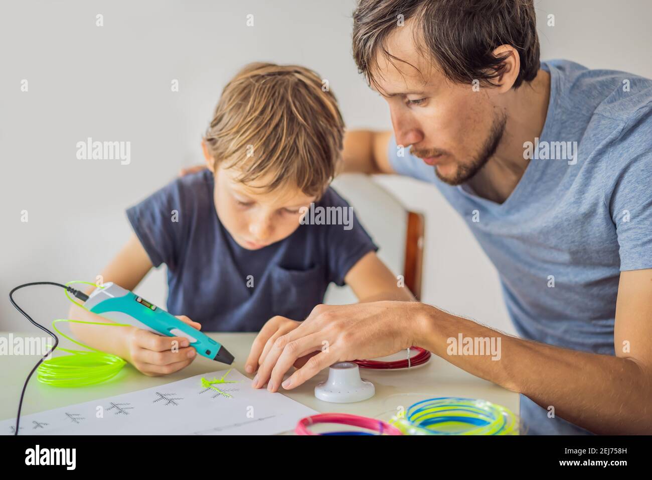 Boy and his father using 3d printing drawing pen. Creative, leisure ...