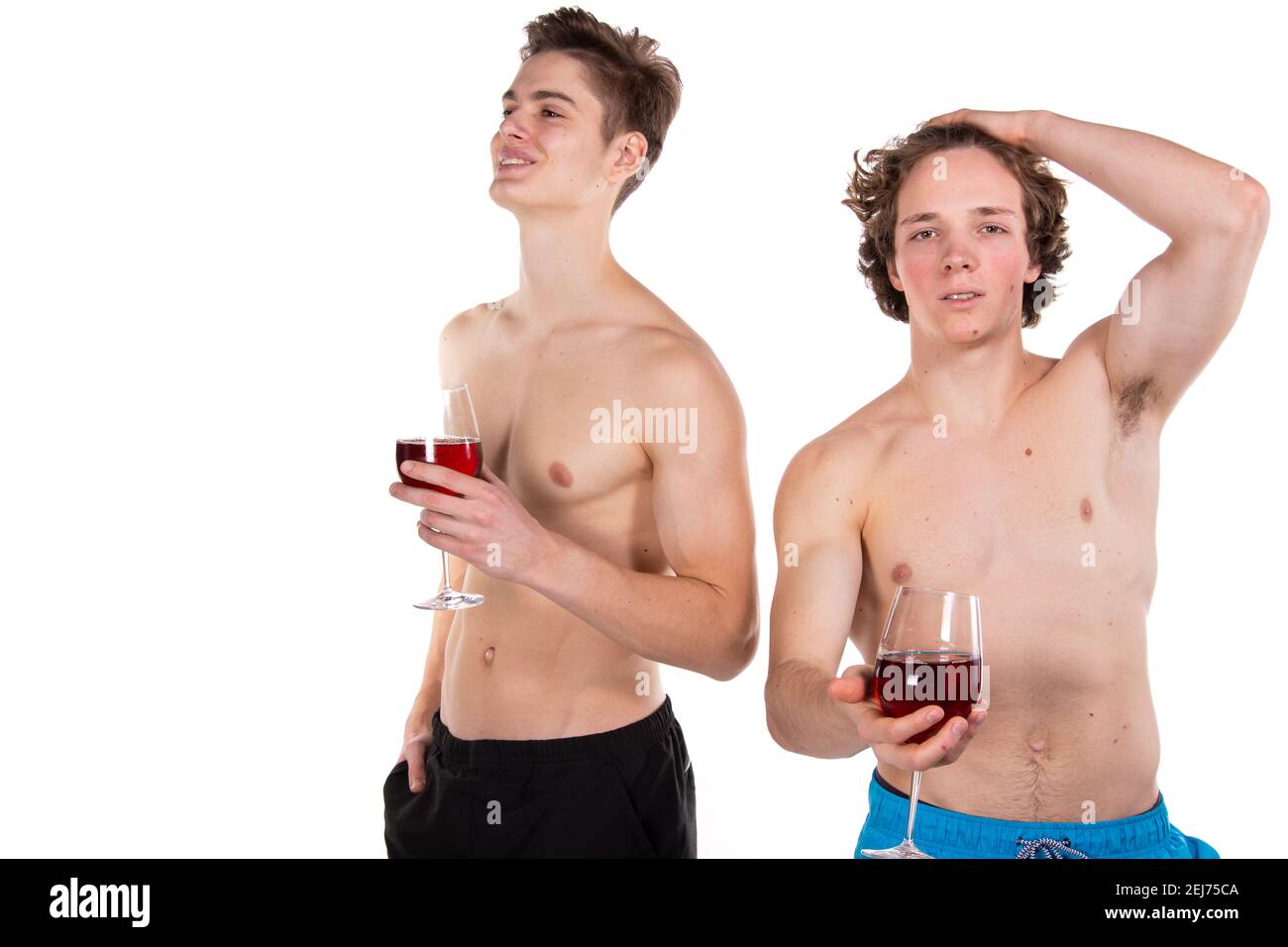 Holidays and weekends. Young attractive couple drinking red wine. White background. Stock Photo