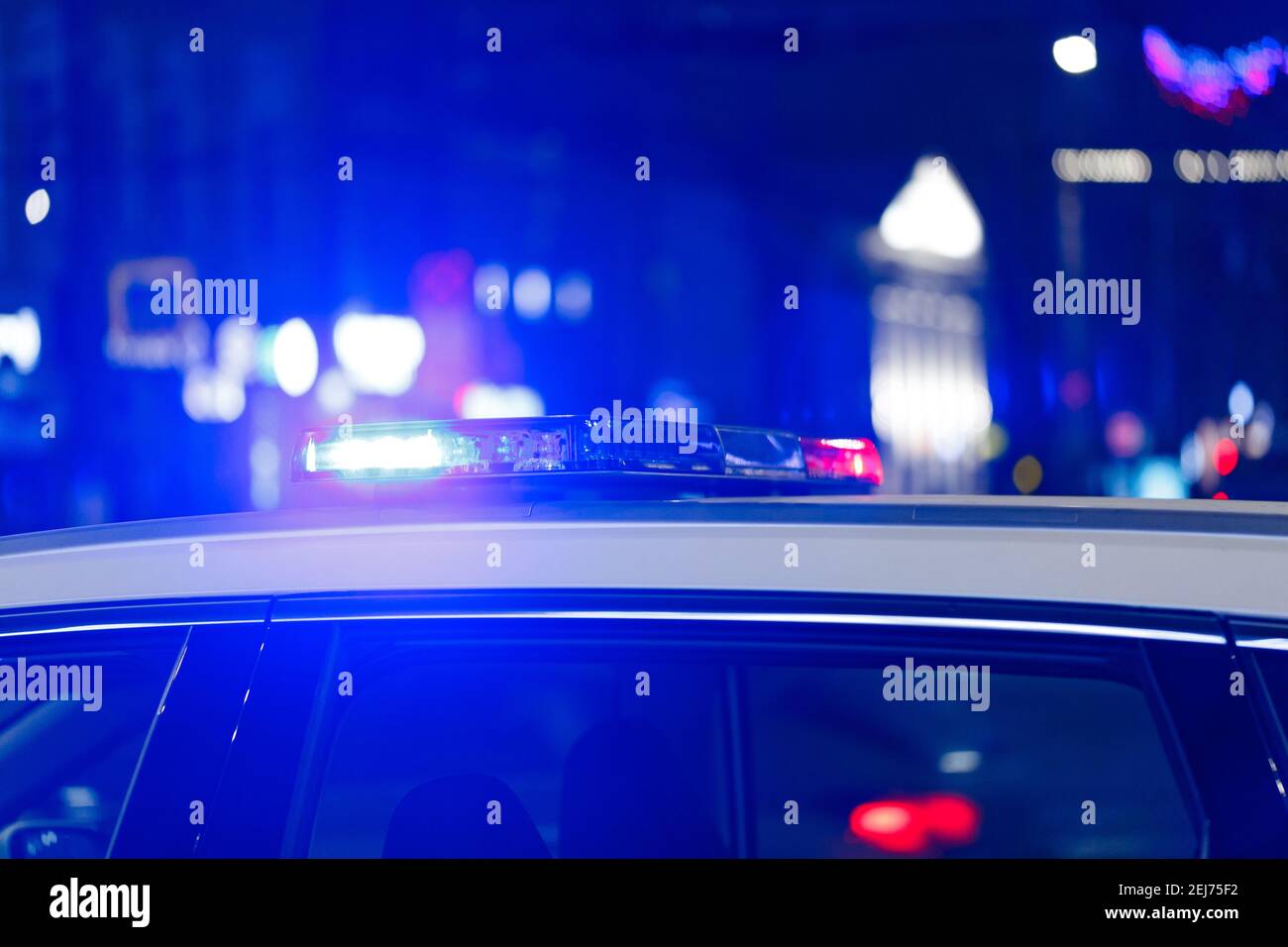 police car lights at night in city with selective focus and bokeh blur ...