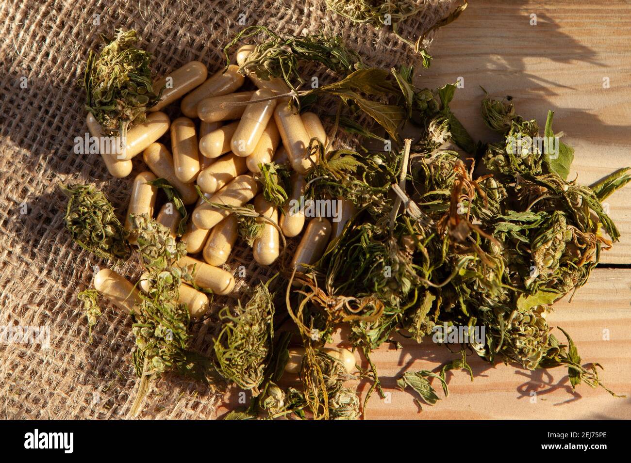herbal extract on a wooden tabletop and a jute fleece. Daylight. Stock Photo