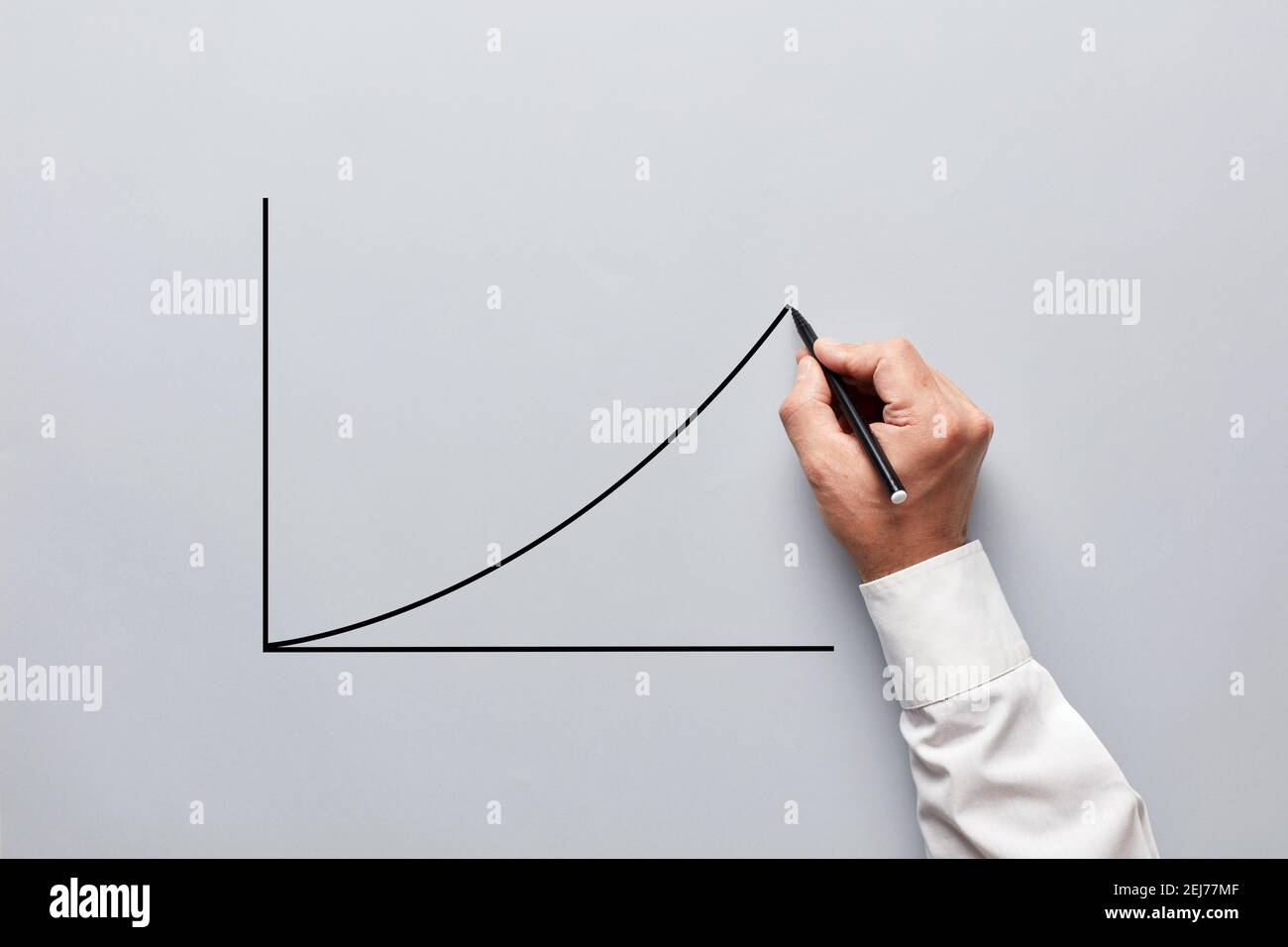 Businessman hand drawing a chart or line graph with an increasing slope ...