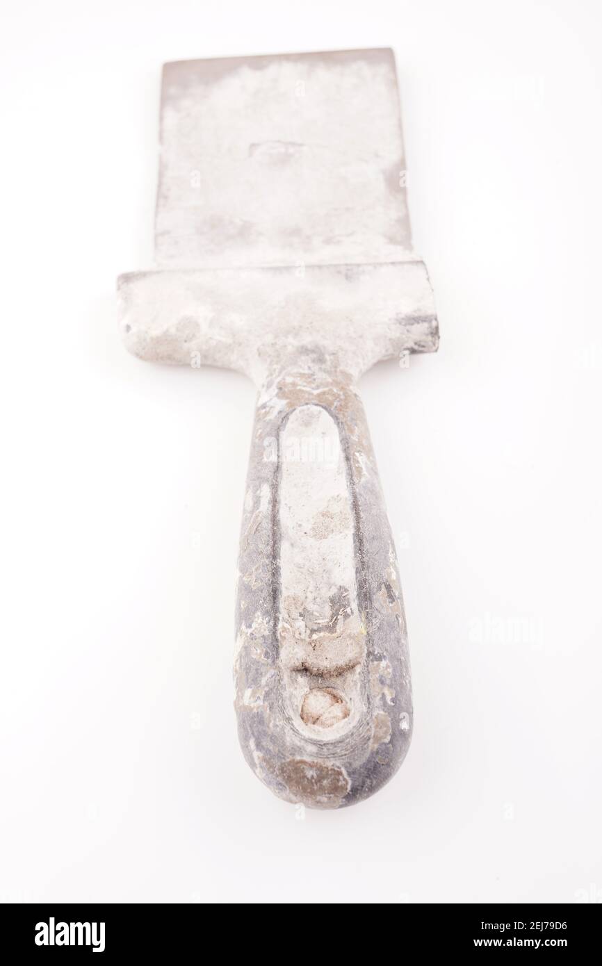 dirty spatula for putty on a white background Stock Photo