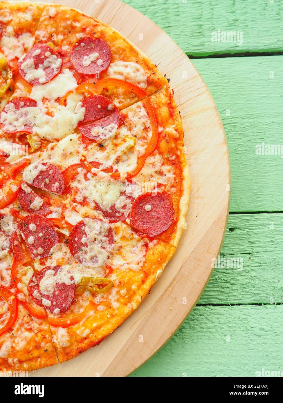 pizza on a wooden green background. Italian kitchen Stock Photo Alamy