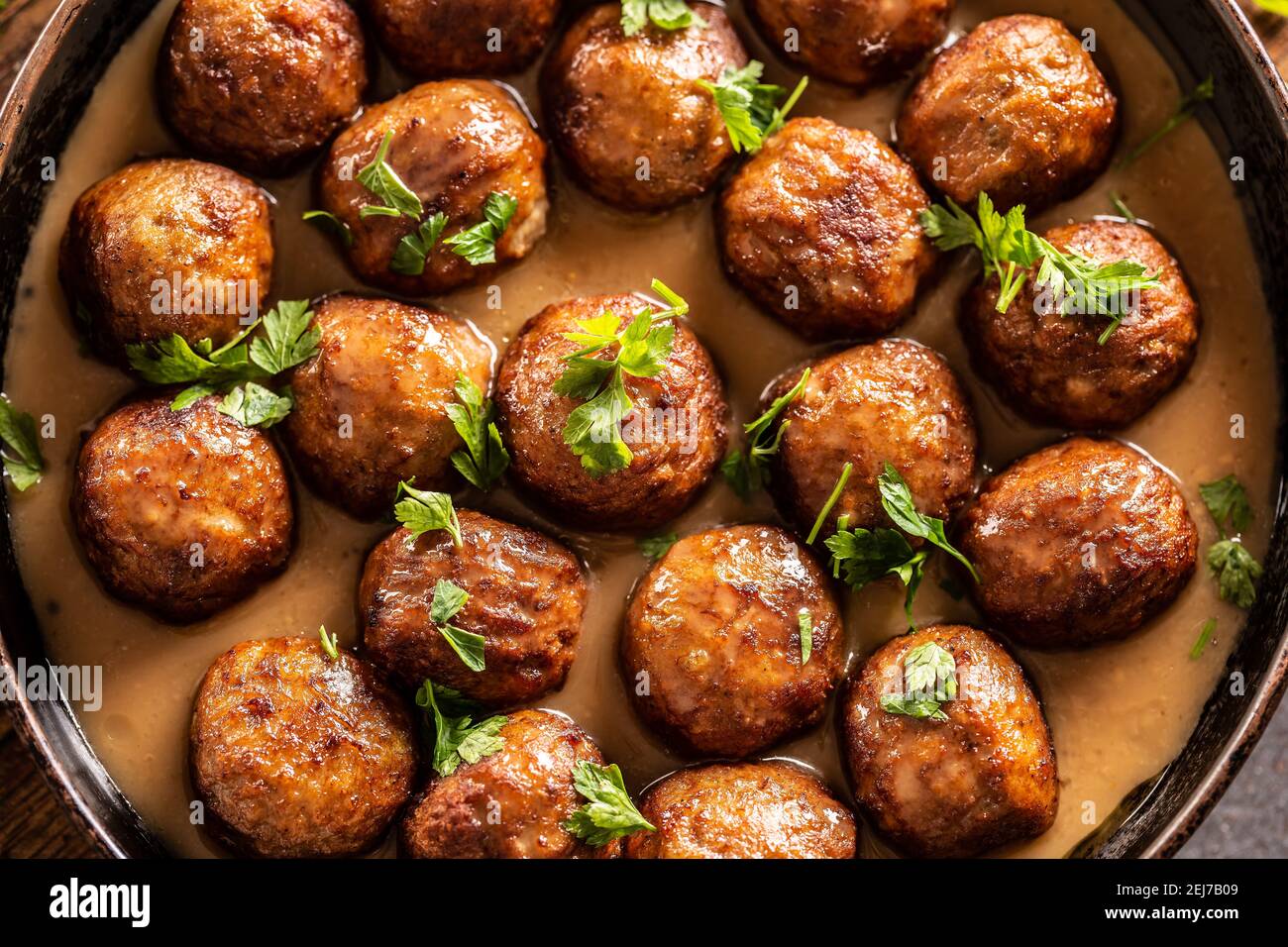 Top view of a pan with freshly-made kottbullar meatballs in a sauce. Stock Photo