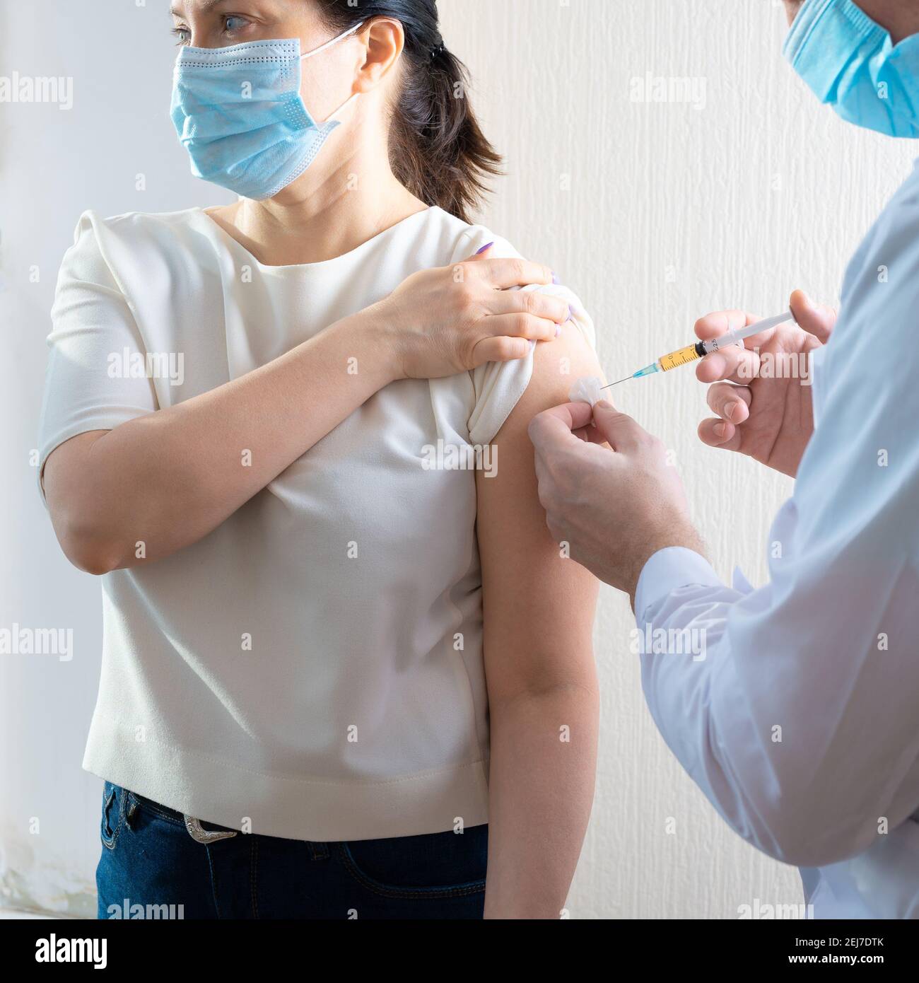 vaccination covid19. Doctor giving Covid vaccine to Mature woman. doctor is injecting female patients. Woman with face mask getting vaccinated, corona Stock Photo