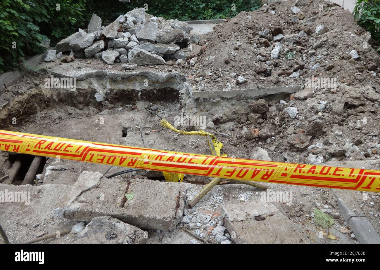 A hole digging by the water service company to replace a damaged