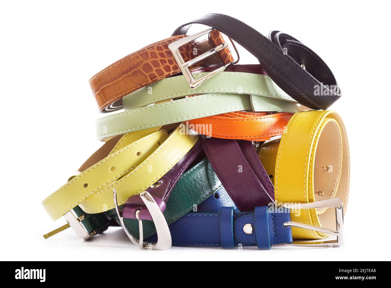 heap of various types of leather belts isolated on white background