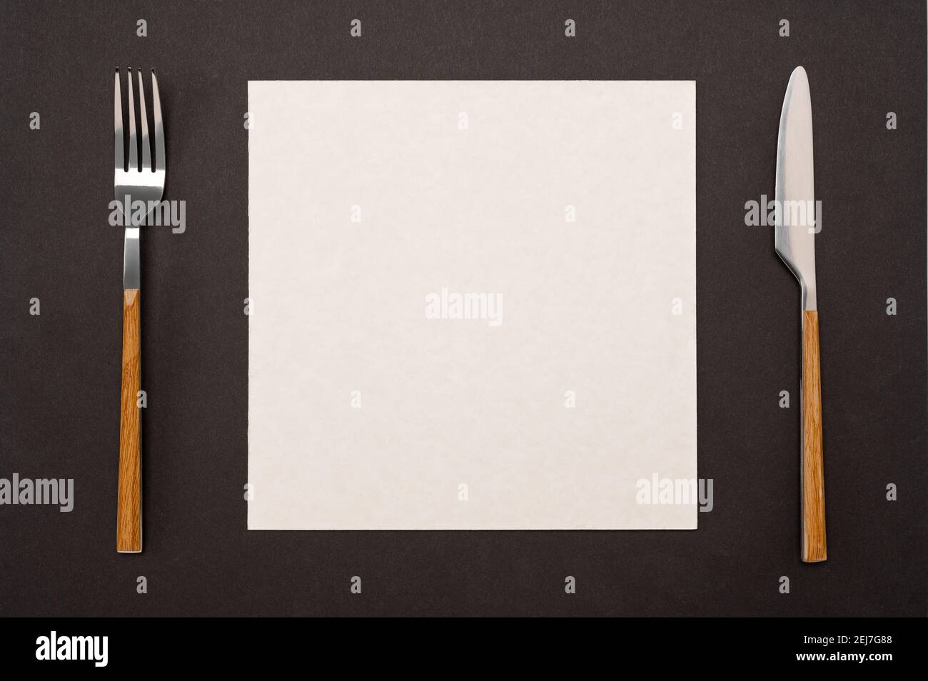 Top view blank recipe menu paper page with mockup text space, invitation card and cutlery on black table background Menu recipe book food blog design Stock Photo