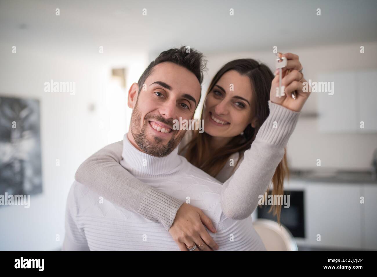 Happy couple showing the keys of their new house Stock Photo - Alamy