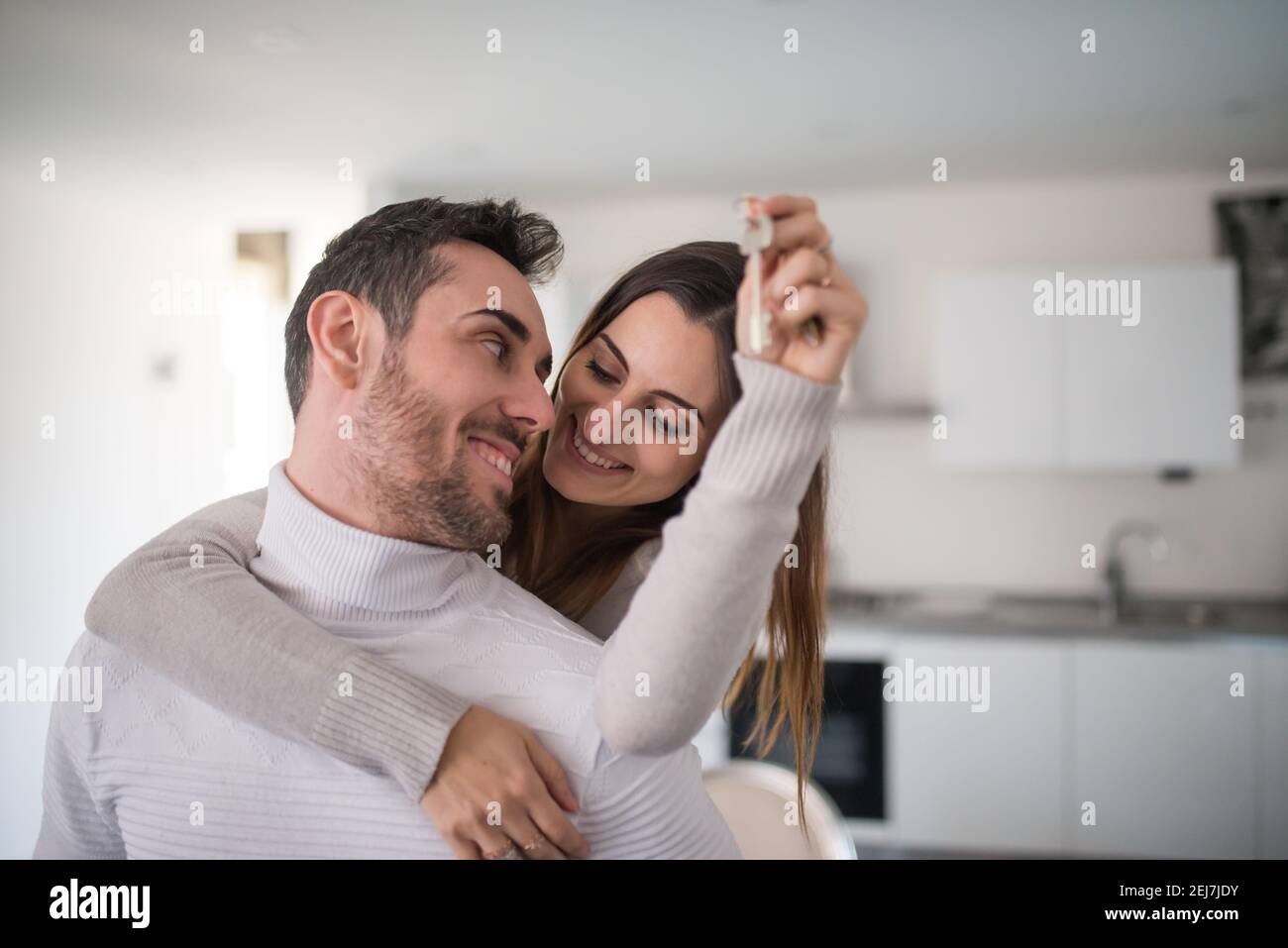 Happy couple showing the keys of their new house Stock Photo - Alamy