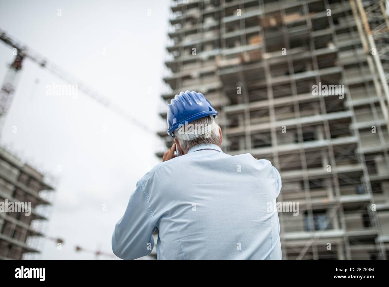 Architect manager talking on the cellphone and pointing his finger to ...