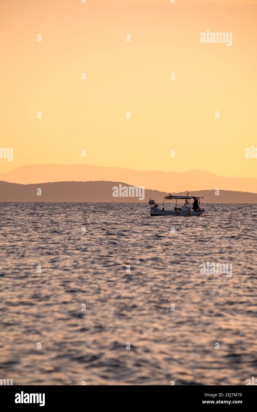Small fishing boat in the Mediterranean at dusk Stock Photo