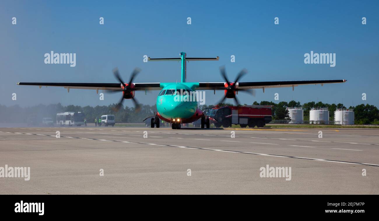 A plane with propellers takes off at the airport. Runway. Propeller