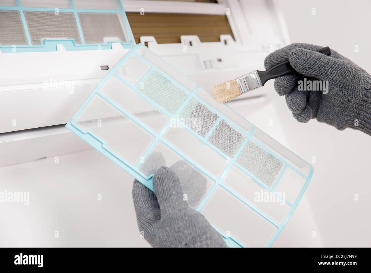 Dirty and dusty air conditioner filter. Cleaning service, wizard fixes