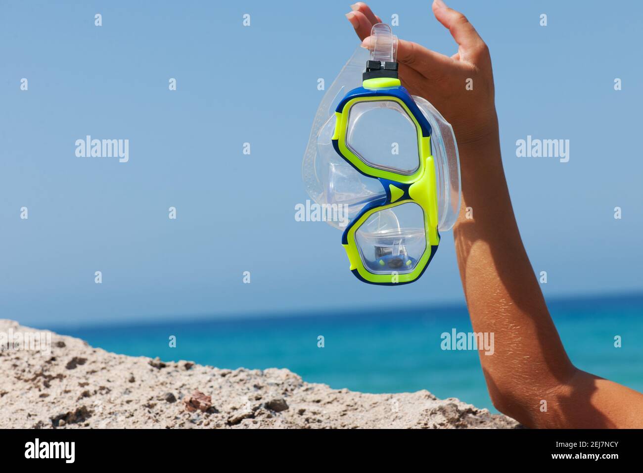 Hand held yellow and blue diving mask with sea background Stock Photo ...
