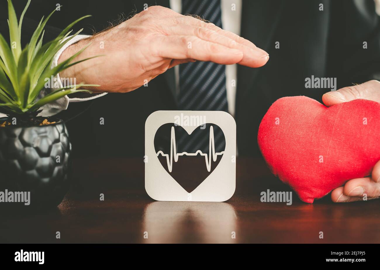 Heartbeat symbol protected by hands - Concept of health insurance Stock ...