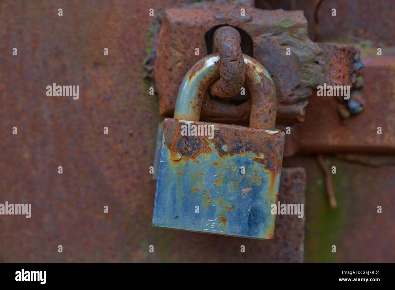 Rusty old padlock on a steel door Stock Photo