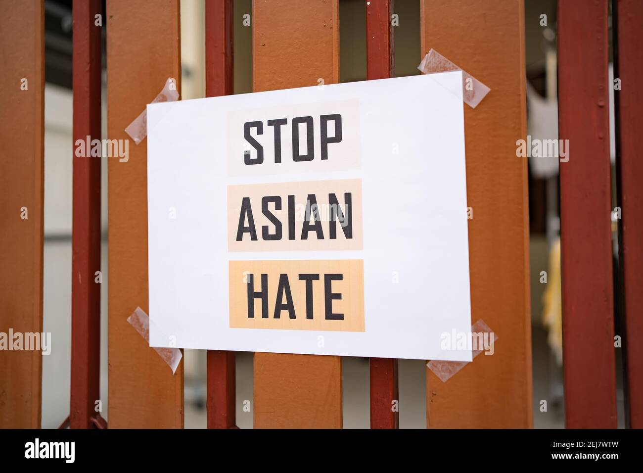 Stop Asian Hate sign was attached on the house fence Stock Photo