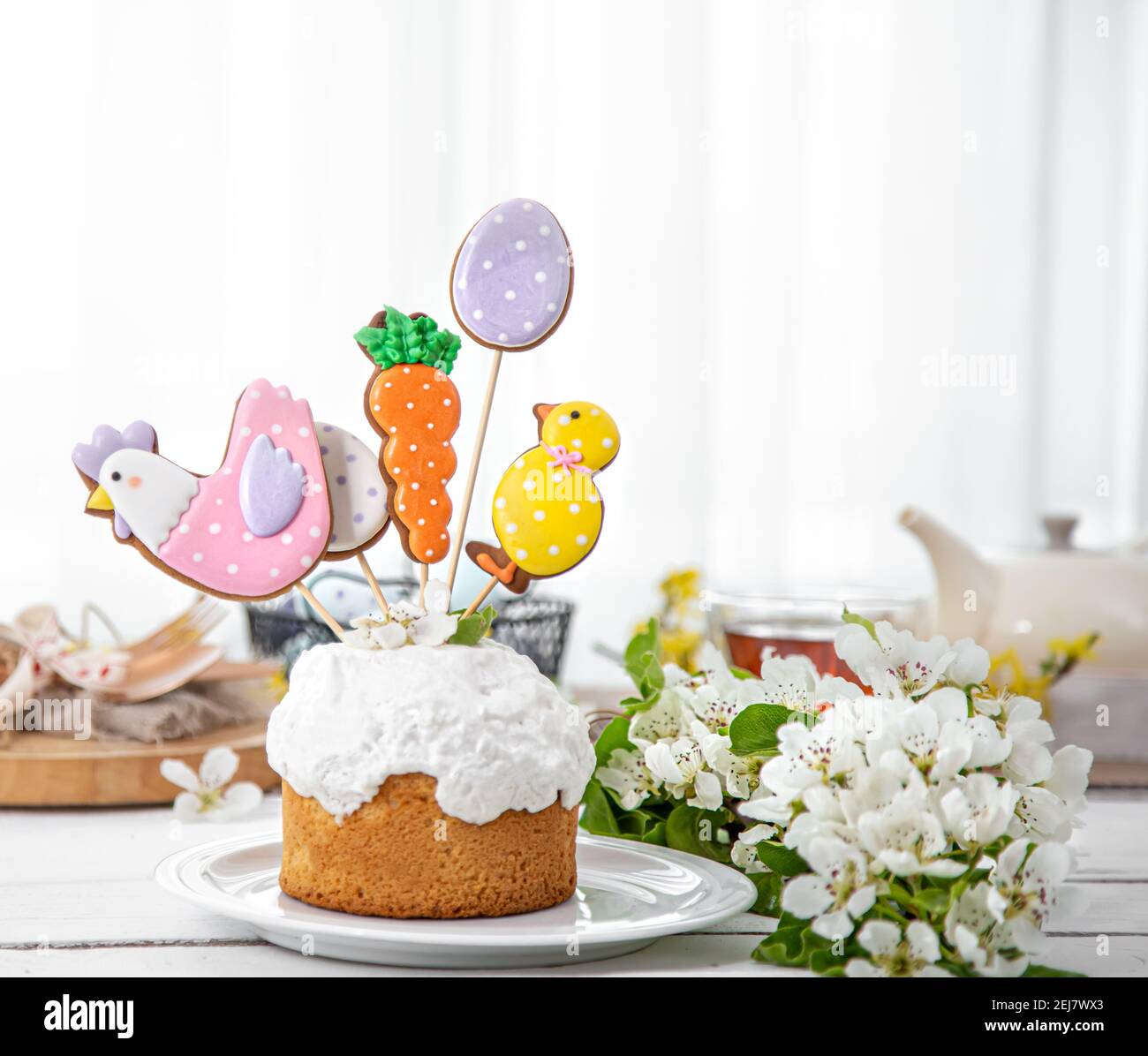 Easter composition with beautifully decorated Easter cake and spring flowers. The concept of preparing for the Easter holiday. Stock Photo