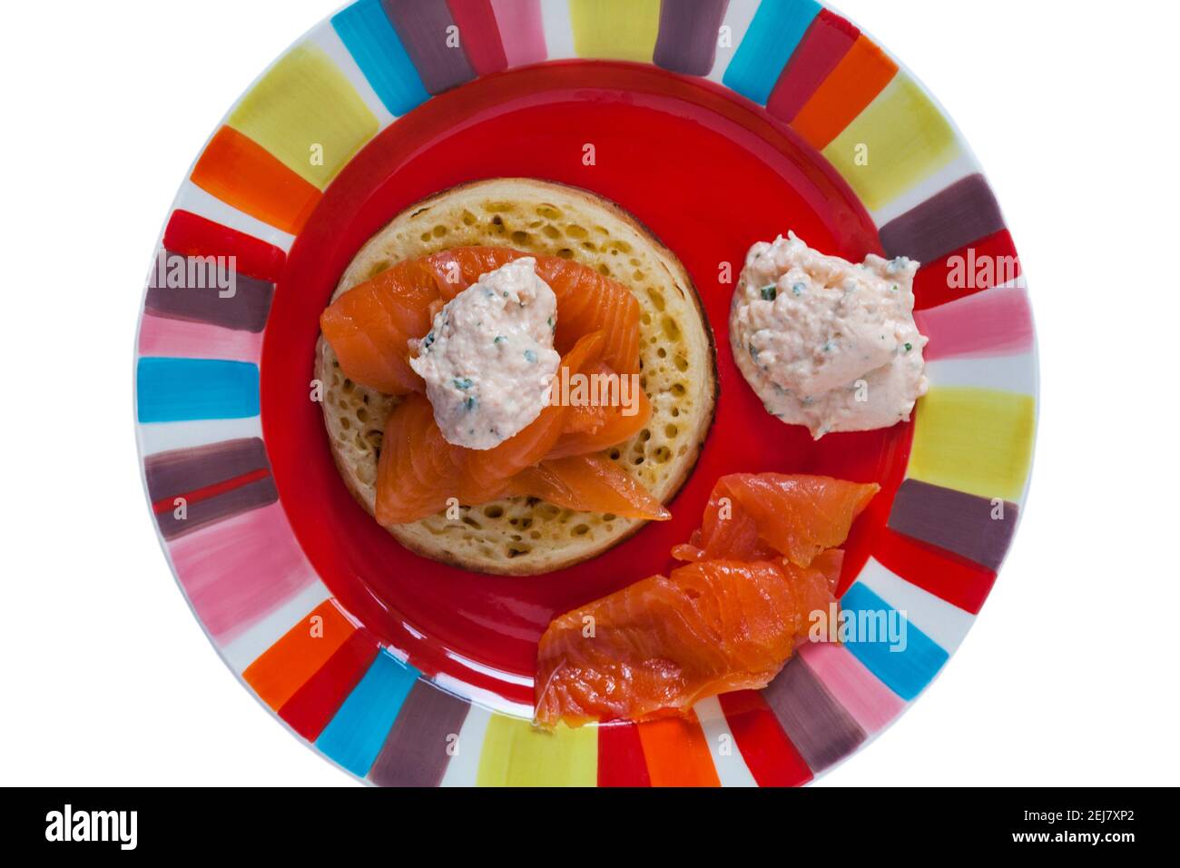 Salmon on crumpet set on colourful plate Stock Photo