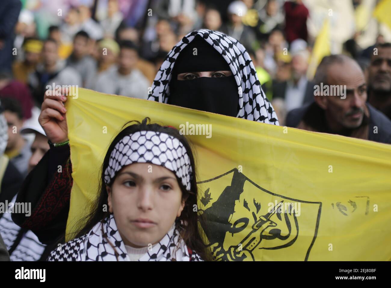 Palestinian women with a Yasser Arafat signature scarf during a rally  marking the 55th anniversary of the Fatah movement founding. Fatah is a  secular Palestinian party and former guerrilla movement founded by