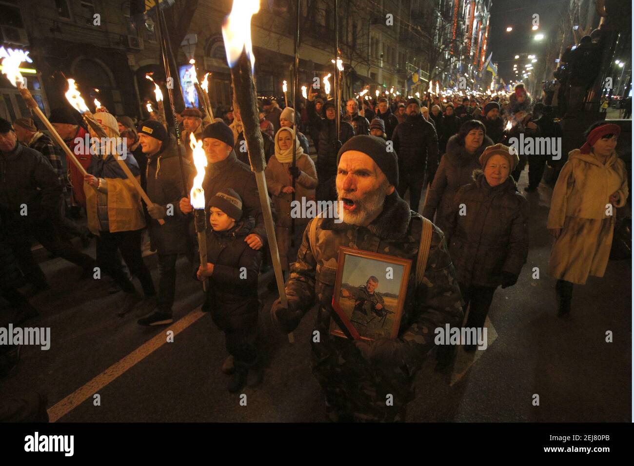 Ukrainian activists hold lit torches during a rally of different ...