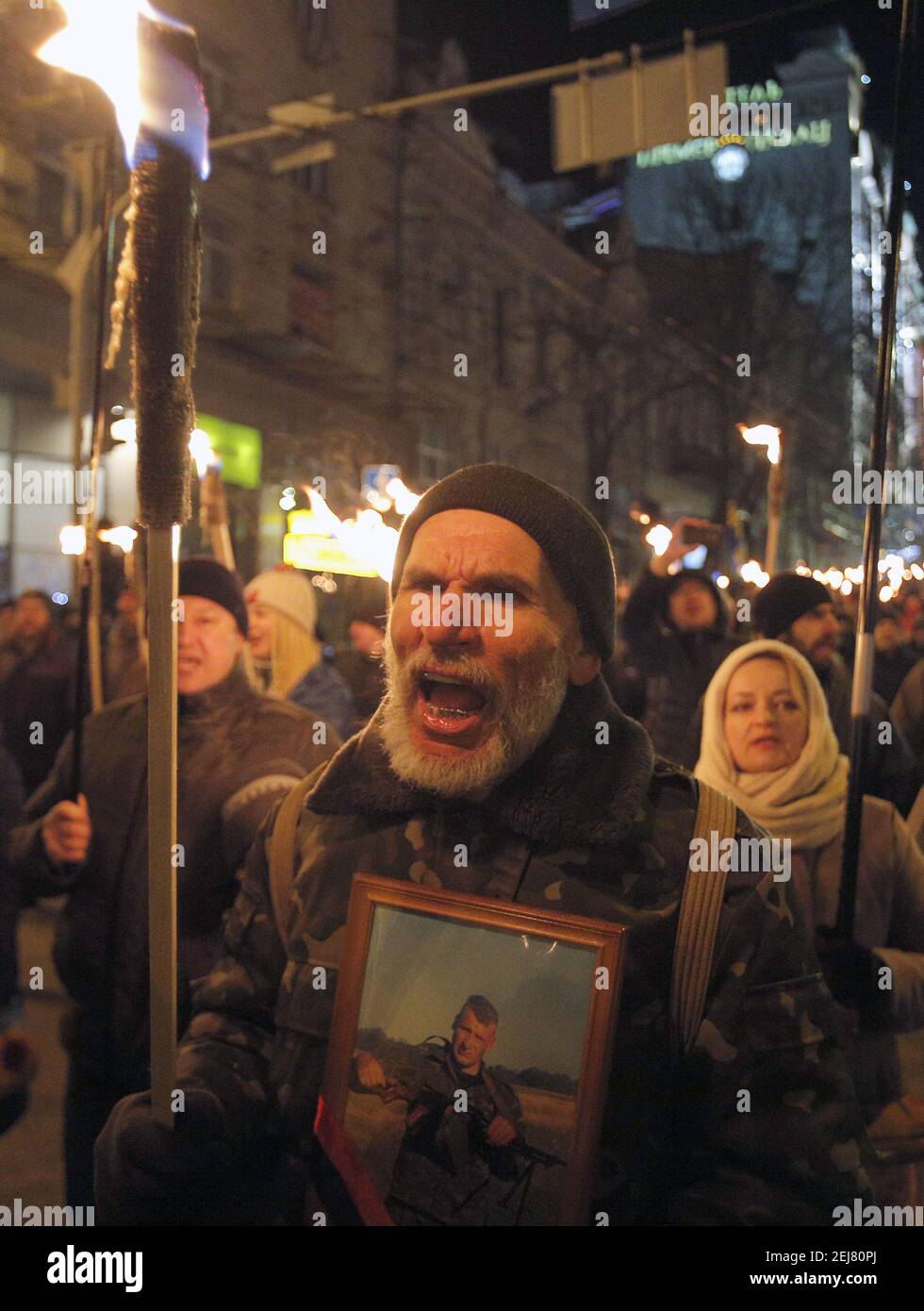 Ukrainian activists hold lit torches during a rally of different ...