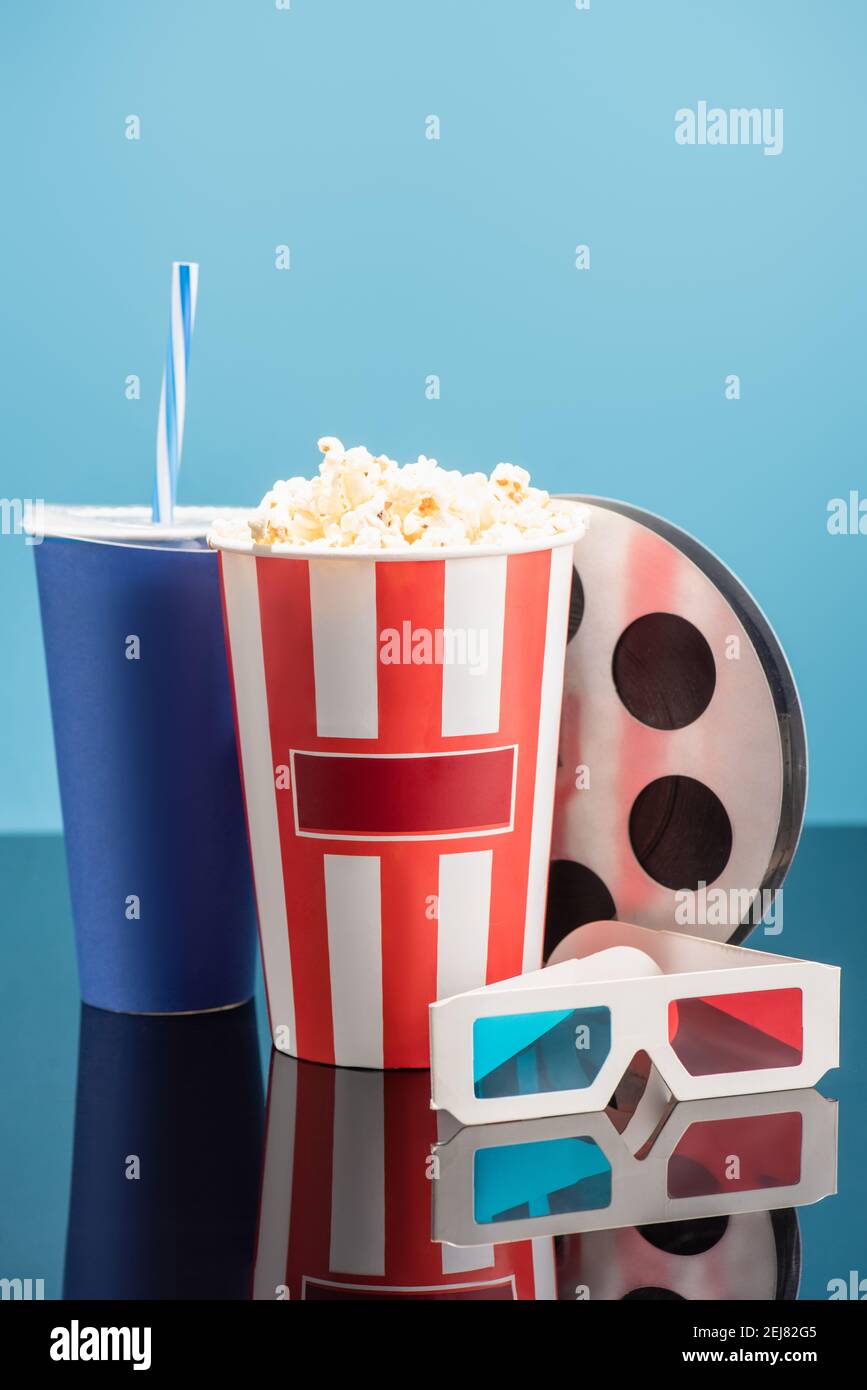 bucket with popcorn, cup with soda, film bobbin and 3d cinema glasses ...