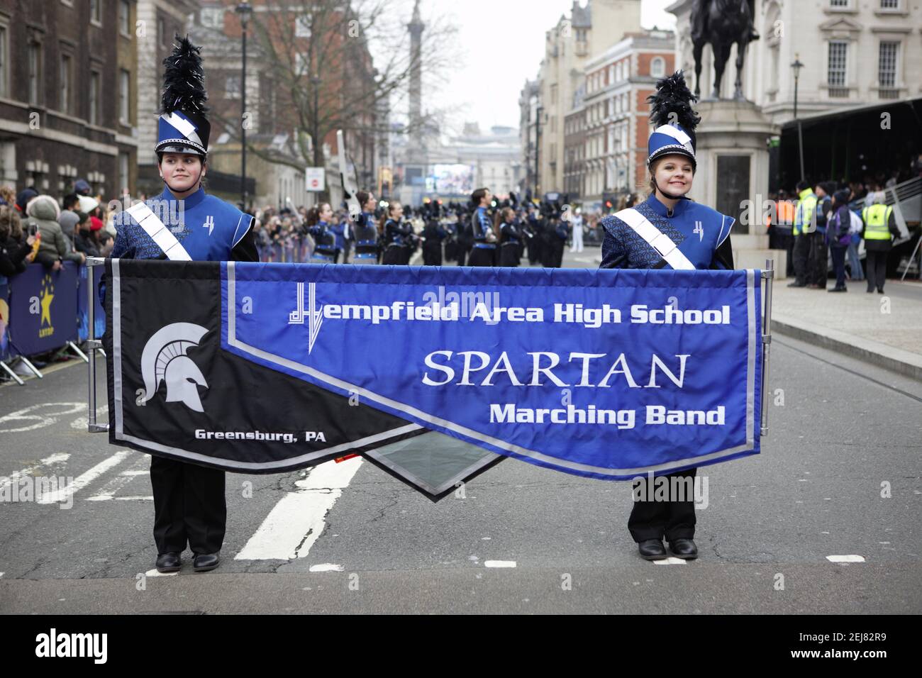 Members of High school Spartan marching band hold a banner during the