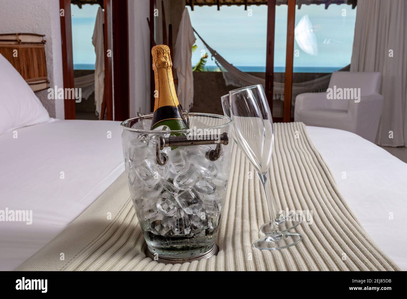 Hotel bed with champagne on the beach Stock Photo