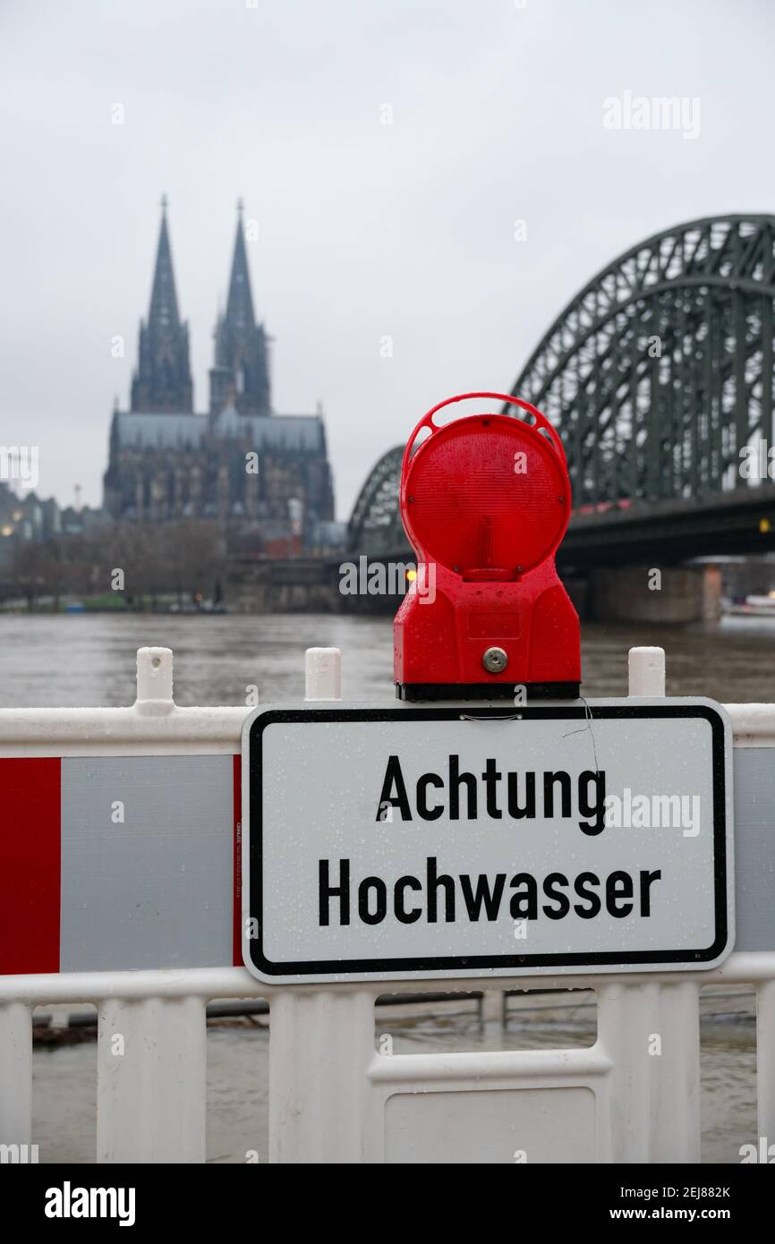 'Achtung Hochwasser - attention high tidewater' sign on the river Rhine in Cologne Stock Photo