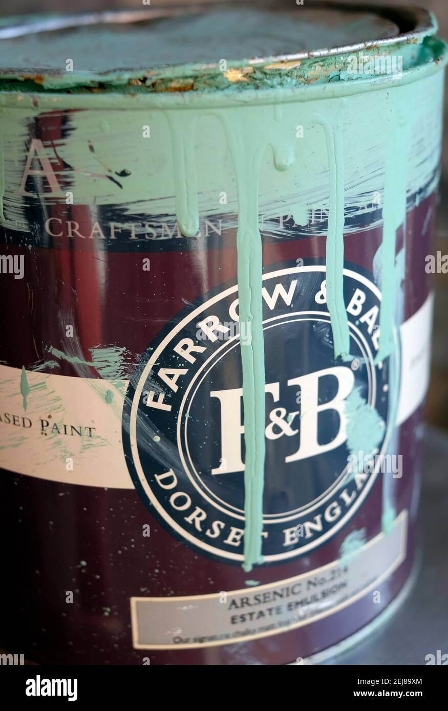 farrow & ball arsenic paint colour running down side of tin Stock Photo