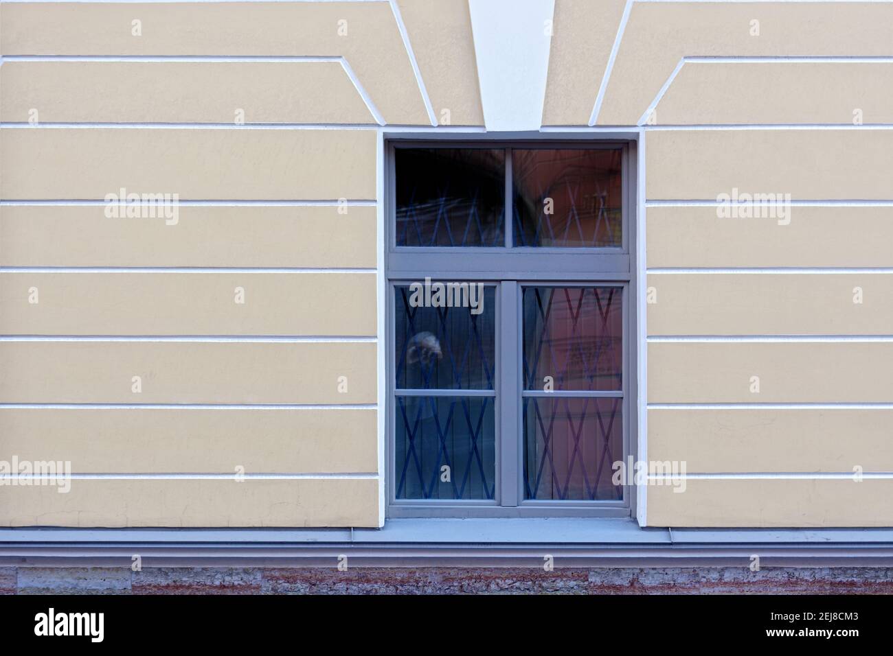 Rectangular window against a yellow plastered wall. From a series of windows of St. Petersburg. Stock Photo