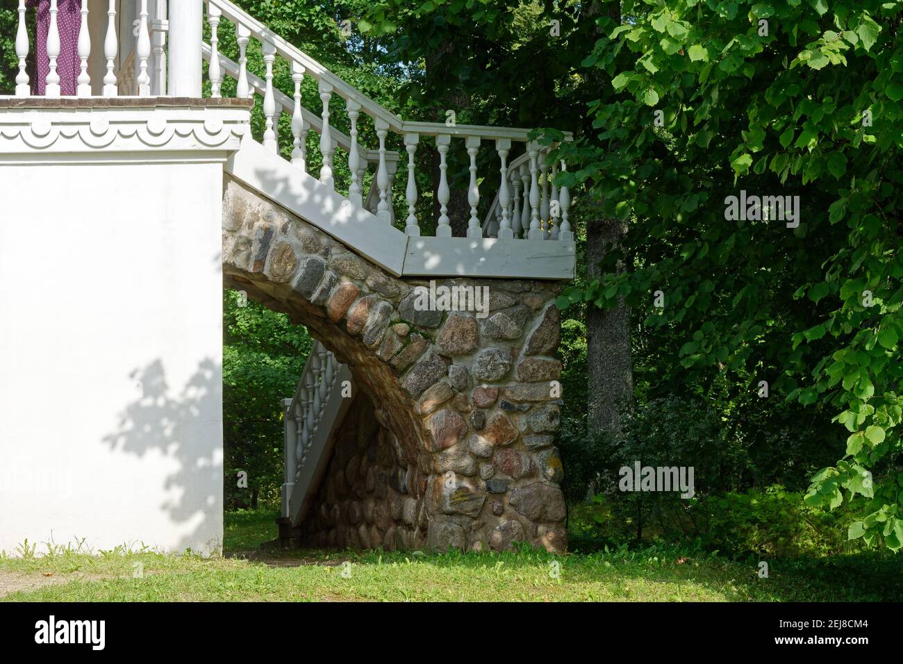 White staircase of the gazebo grotto with a stone arch in the park of the Petrovskoe estate in Pushkinskiye Gory. Stock Photo