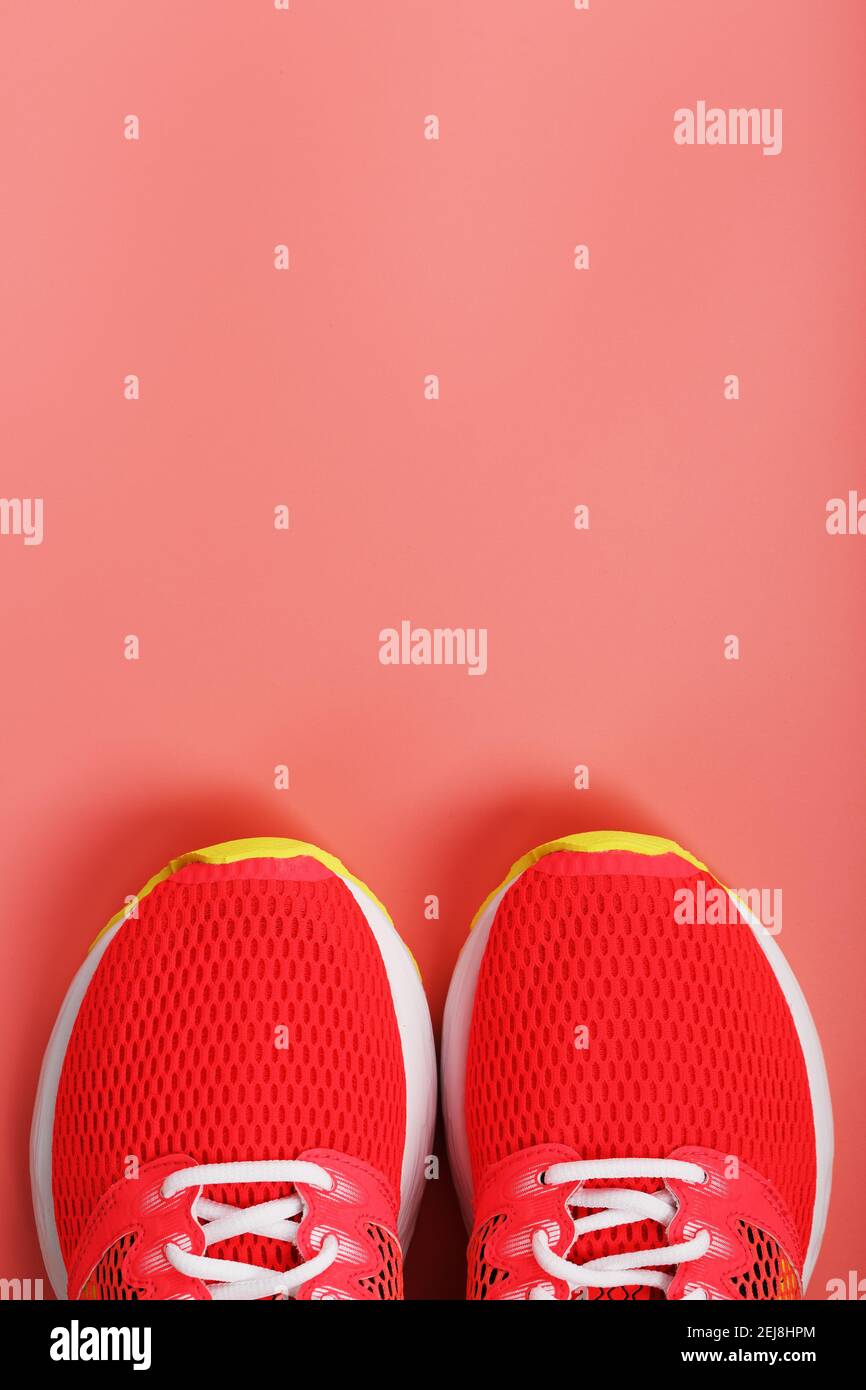 Sports pink sneakers on a pink background with free space. Top view ...